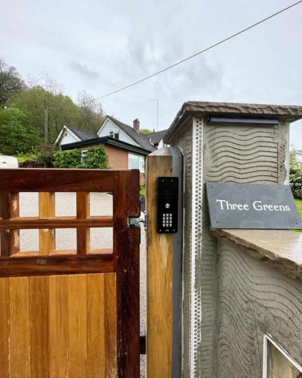 Video intercom fitted beside a wooden security gate