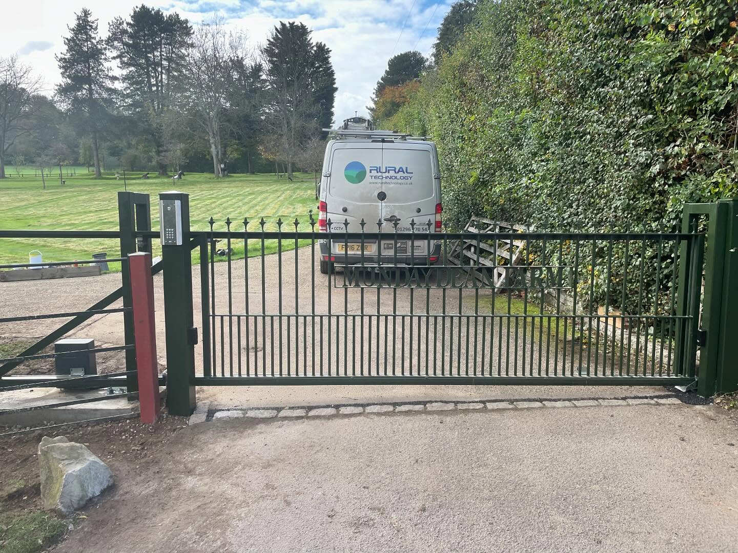 Black steel security gate with a Rural Technology van behind it
