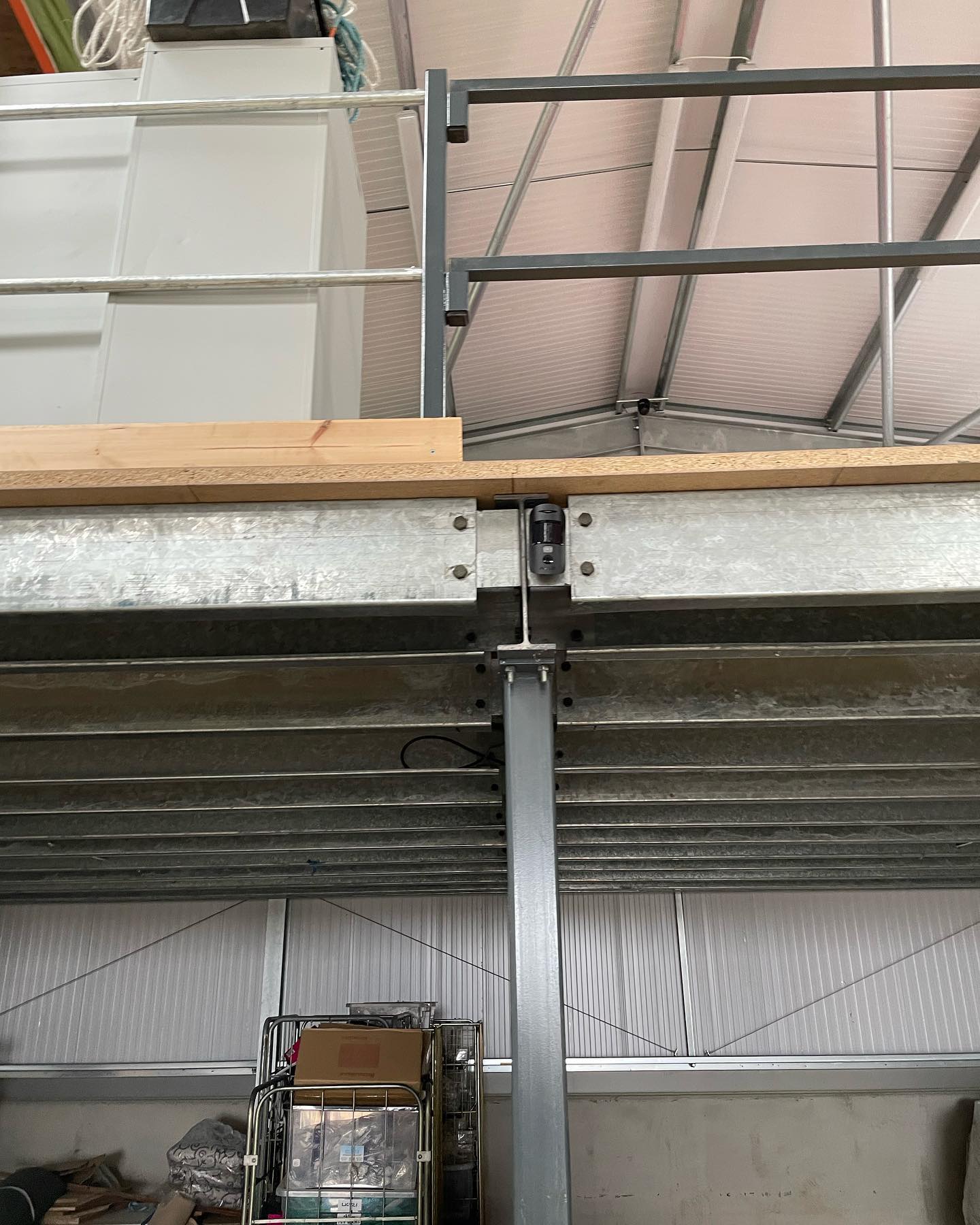 Detector for farmyard alarm systems fitted to a steel beam inside a farm building