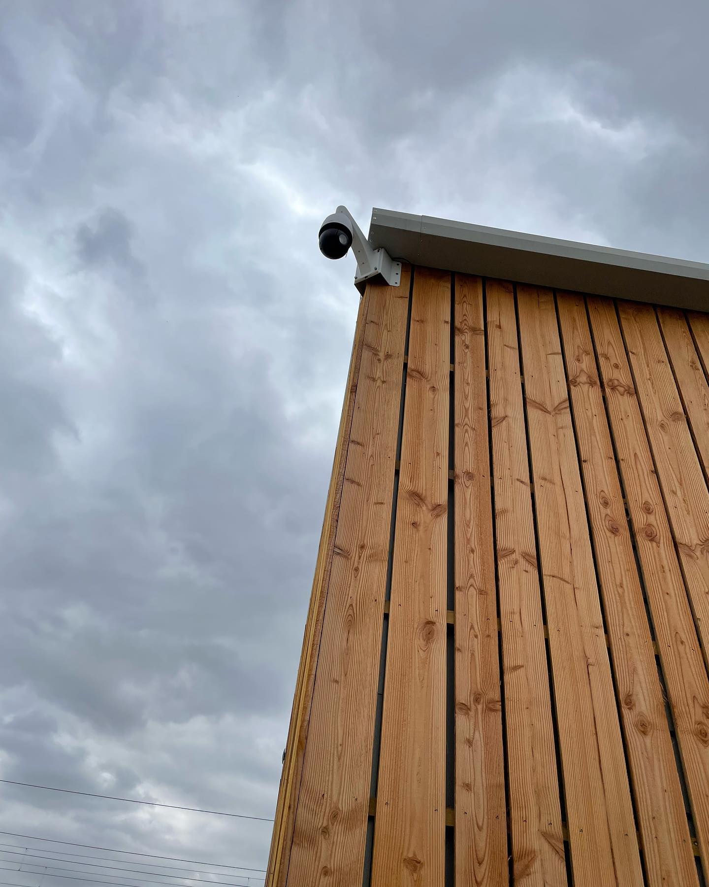 Farm CCTV systems: security camera mounted at the corner of a timber building