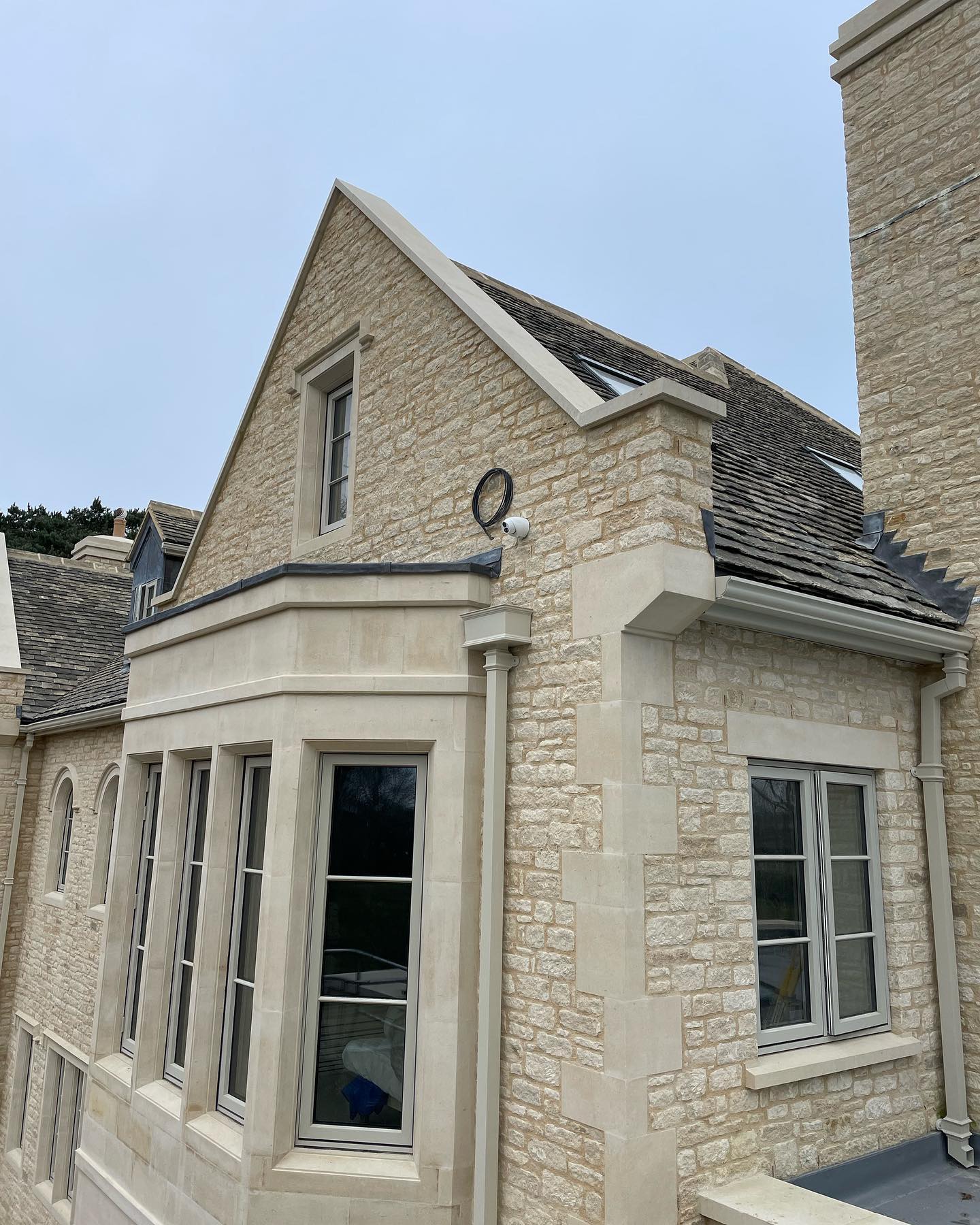 CCTV camera mounted beneath the gable of a rural house
