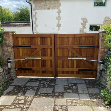 Automatic gate openers fitted to double wooden security gates