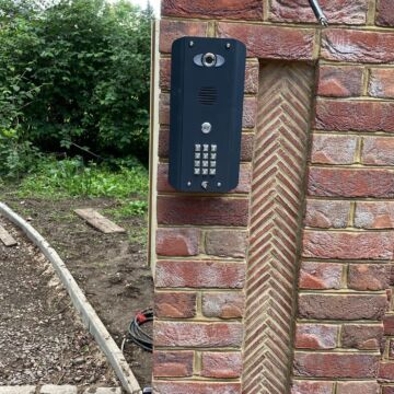 Video intercom and keypad mounted on a brick gate pillar