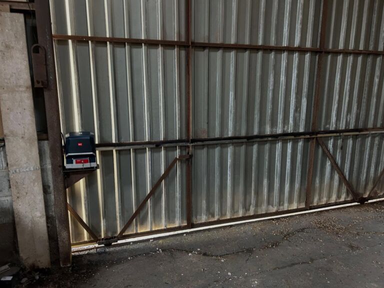 Control panel for farmyard alarm systems mounted on a corrugated agricultural building door