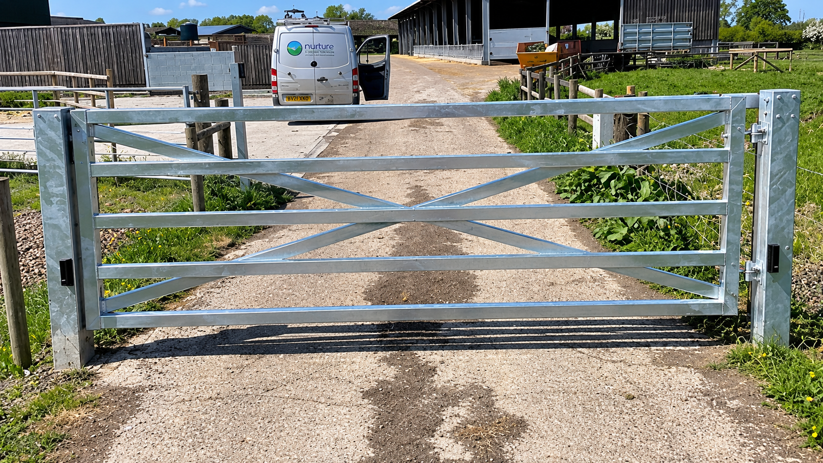Galvanised farm gate securing a rural driveway